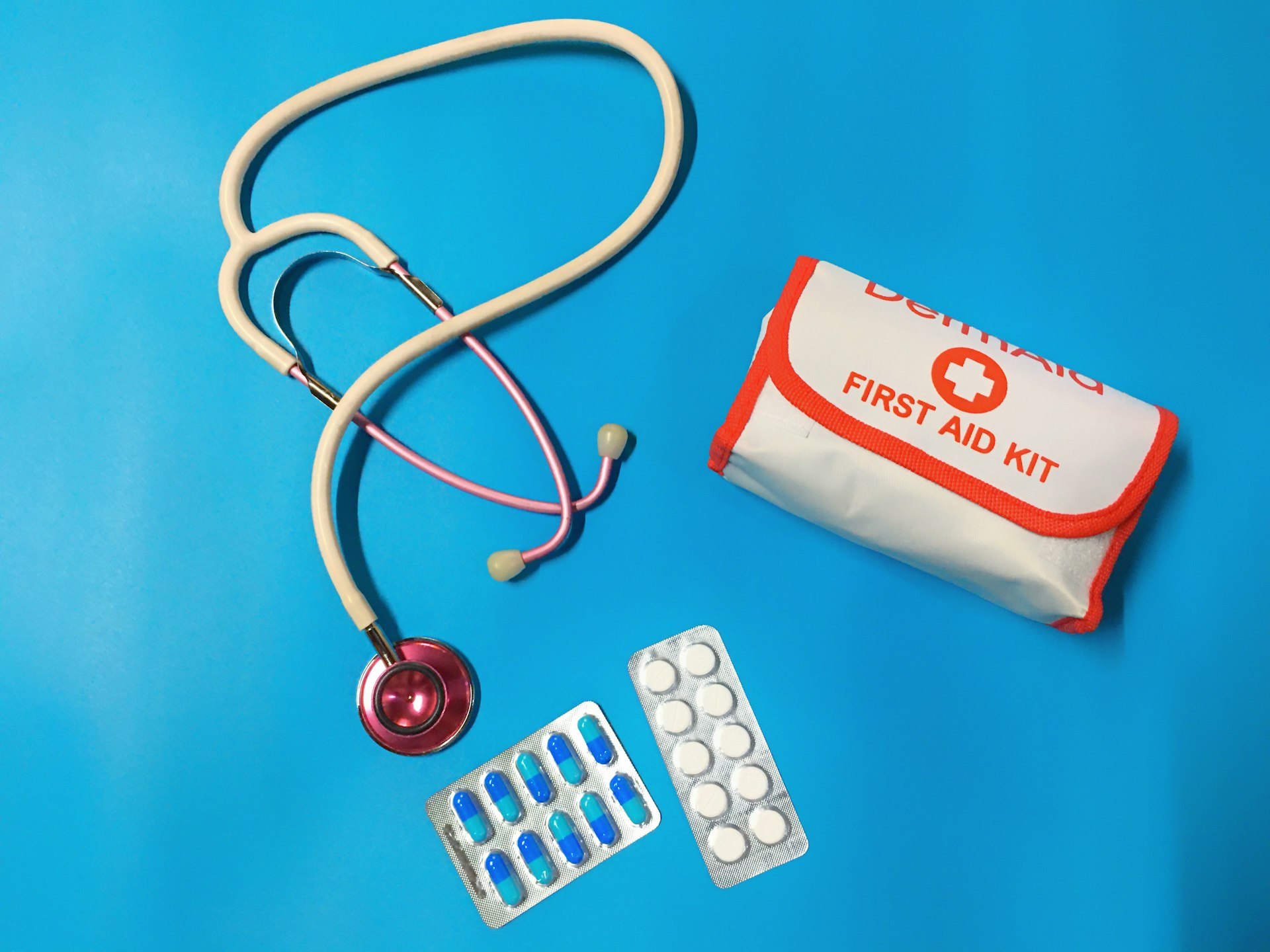 a bag of pills, a stethoscope, and a first aid kit